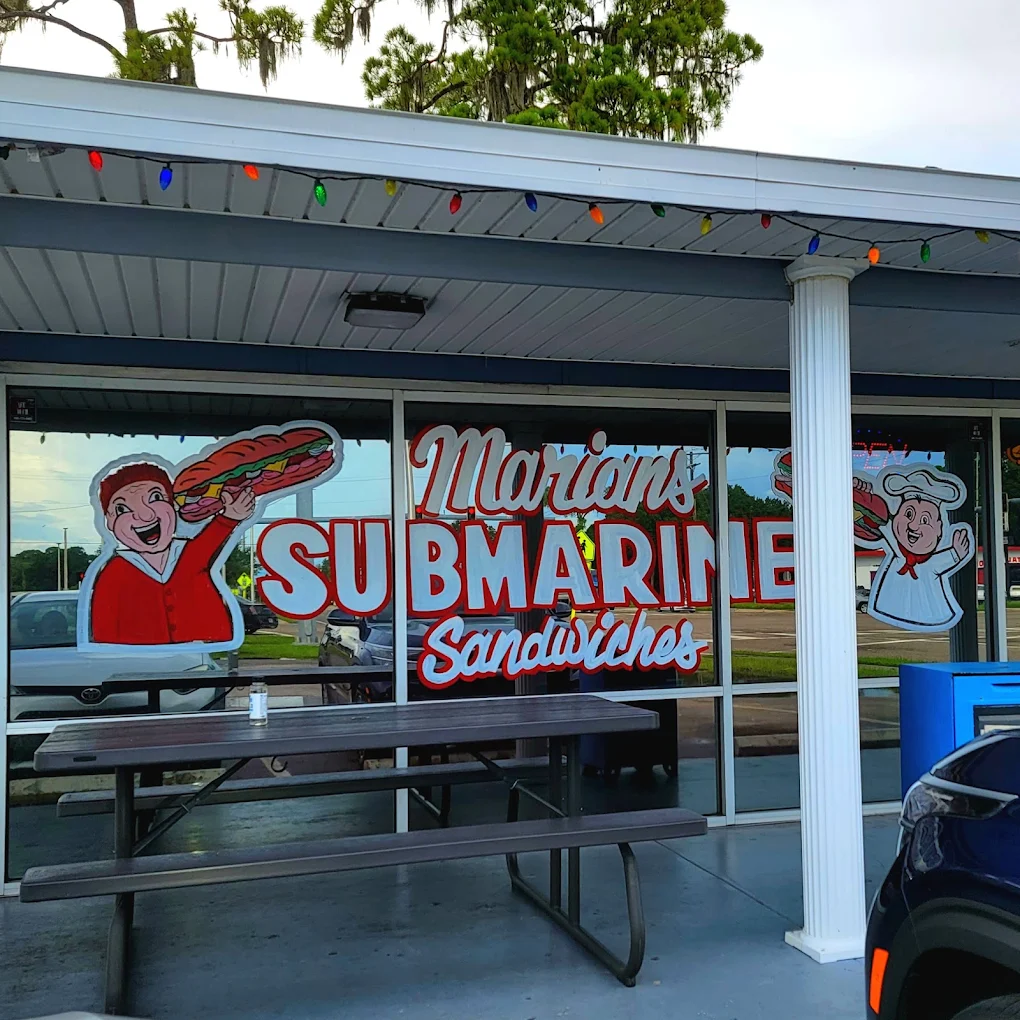 The hand-painted Marian's Submarine Sandwiches window with picnic table